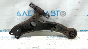 The lower front right control arm of a Toyota Camry v40 is rusty and the silent block is torn.