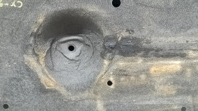 The left underbody protection of the Mazda CX-9 16-23 is dented and scuffed.