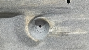 The left underbody protection of the Mazda CX-9 16-23 is dented and scuffed.