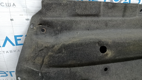 The left underbody protection of the Mazda CX-9 16-23 is dented and scuffed.