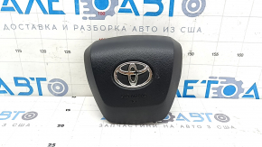 Black, worn steering wheel airbag for the driver's side of a Toyota Sienna 21-24.