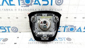 Black, worn steering wheel airbag for the driver's side of a Toyota Sienna 21-24.