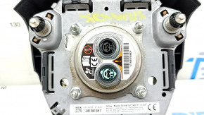Black, worn steering wheel airbag for the driver's side of a Toyota Sienna 21-24.