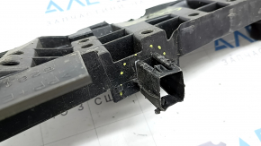 The lower front bumper absorber of a Toyota Sienna 21-24 is dented and the mount is broken.