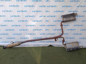 The exhaust pipe, the middle part of a Toyota Camry v40 3.5, is dented and rusty.
