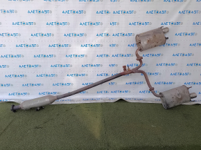 The exhaust pipe, the middle part of a Toyota Camry v40 3.5, is dented and rusty.
