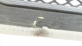 The front plastic windshield wiper grille of a Porsche Macan 2015-2018 is cracked.