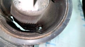 The rear left trailing arm of a Toyota Sienna 21-24 has a cracked silent block.