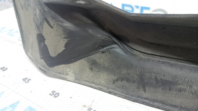 The left front bumper mudguard of a Nissan Rogue 21-24 is dented.