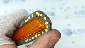 The left front bumper reflector on a BMW X5 G05 19-24 has come unglued.