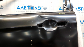 The front left door of a Ford Escape MK3 2013-2019 is bare, with dents and bumps.