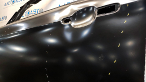 The front left door of a Ford Escape MK3 2013-2019 is bare, with dents and bumps.