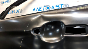 The front left door of a Ford Escape MK3 2013-2019 is bare, with dents and bumps.