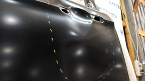 The front left door of a Ford Escape MK3 2013-2019 is bare, with dents and bumps.