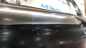 The front left door of a Ford Escape MK3 2013-2019 is bare, with dents and bumps.
