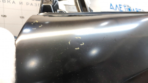 The front left door of a Ford Escape MK3 2013-2019 is bare, with dents and bumps.