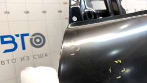 The front left door of a Ford Escape MK3 2013-2019 is bare, with dents and bumps.