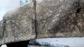 The rear left fender liner of a Ford Focus mk3 11-18 is torn and has cracks.