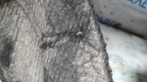 The rear left fender liner of a Ford Focus mk3 11-18 is torn and has cracks.