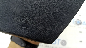 The driver's side airbag in the Toyota Prius V 12-17 is black, scratched, and has a rusty squib.