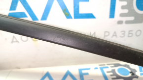 Upper front right door molding for a 1993 Chevrolet Camaro, black, with some wear.
