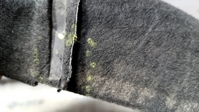 The rear left fender liner of a Ford Mustang mk6 15-23 has a torn seam.