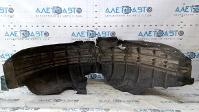 The rear left fender liner of a VW Beetle 12-19 is torn, the fastener is torn, the seam is torn, a fragment is missing