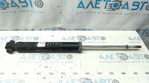 The rear right shock absorber of a Toyota Prius V 12-14 is dented.
