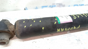The rear right shock absorber of a Toyota Prius V 12-14 is dented.