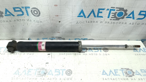 The rear right shock absorber of a Toyota Prius V 12-14 is dented.