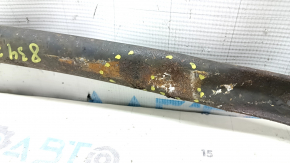 The rear beam strut of a Toyota Prius V 12-17 is dented and rusty.