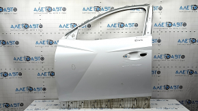 The door is bare, front left, Hyundai Tucson 22-24, white TW3, dent, bump
