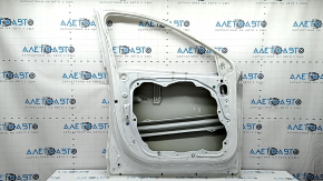 The door is bare, front left, Hyundai Tucson 22-24, white TW3, dent, bump