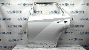The bare rear left door of a Hyundai Tucson 22-24 white TW3, dents
