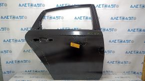 The rear right door of a Honda Accord is bare and has dents.