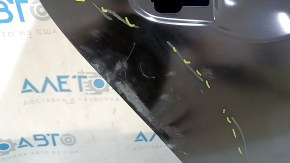 The rear right door of a Honda Accord is bare and has dents.