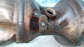 The exhaust manifold with a catalytic converter on a Nissan Rogue 14-19 has a broken bolt.