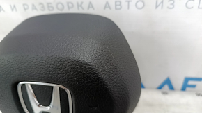 The Honda Accord 2023-2024 driver's steering wheel airbag is black and scratched.