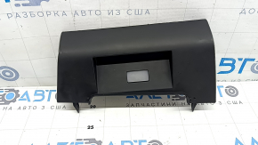 The lower central trim panel of the Hyundai Tucson 22-24 is black, worn, scratched, and the fastener is broken.