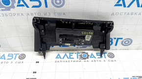 The lower central trim panel of the Hyundai Tucson 22-24 is black, worn, scratched, and the fastener is broken.
