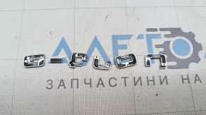The E-TRON emblem on the Audi E-Tron 19-23 trunk door is chrome.