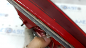 The right inner tailgate light for a Kia Niro 17-22 halogen is worn and the seal is peeling off.