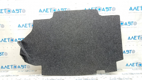 The trunk floor of a Toyota Camry v50 12-12 hybrid USA is gray, with creases and tears.