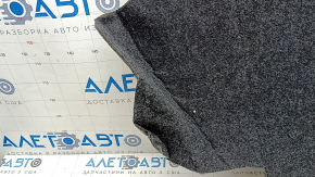 The trunk floor of a Toyota Camry v50 12-12 hybrid USA is gray, with creases and tears.