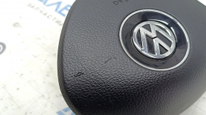 The driver's side airbag in the steering wheel of a VW Tiguan 18-21 is black and scratched.