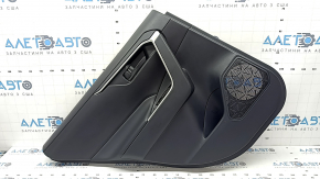 The door trim panel, rear left, Toyota Rav4 19-24, is black, the armrest is black leather, the insert is black plastic, the molding with the handle is gray, scratches are visible.