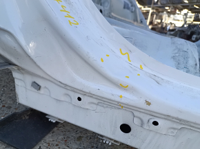 The rear right fender of a Chevrolet Equinox 18-24 is sunken on the body, white, dented