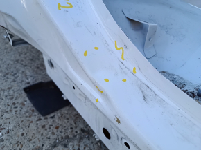 The rear right fender of a Chevrolet Equinox 18-24 is sunken on the body, white, dented