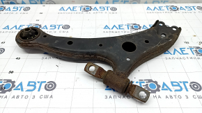 The lower front right control arm of a Toyota Camry V50 12-14 USA is rusty and has a cracked silent block.