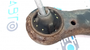 The lower front left control arm of a Toyota Camry V50 12-14 USA is rusty and has a cracked silent block.